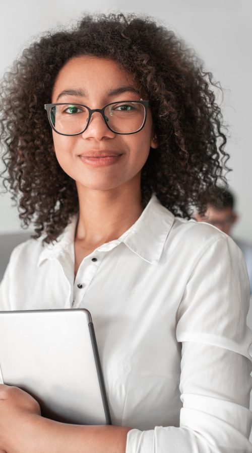 smiling-ethnic-female-recruiter-with-tablet-looking-at-camera-in-office.jpg